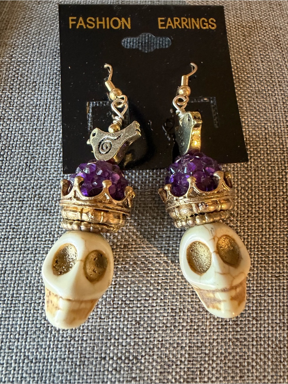 Gold Skull Drop Earrings with Purple Crystal Crown